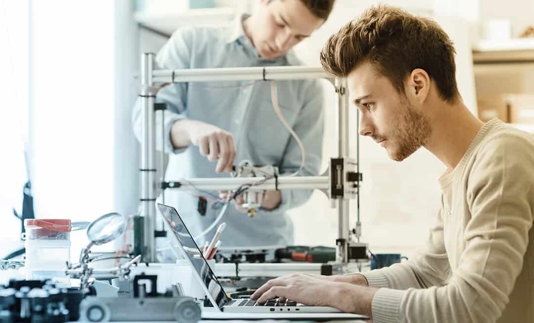 Two young engineers working on a project